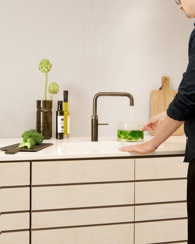 Quooker Fusion Square in gunmetal boiling water tap — blanching broccoli in a real customer kitchen. Genuine Quooker product supplied by Watertap.eu.