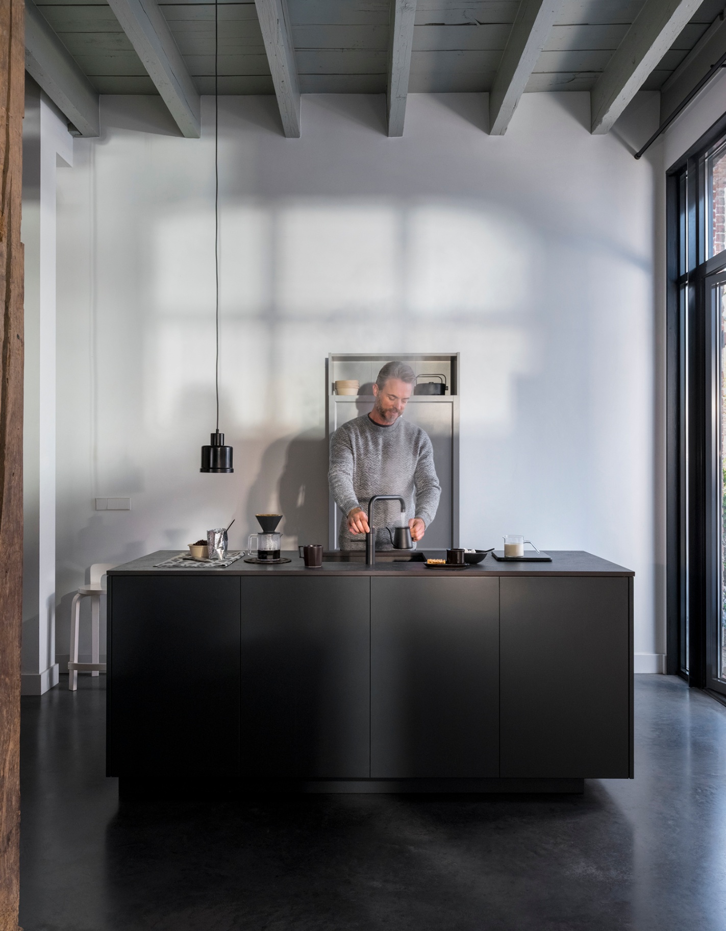 Quooker Fusion Square in matte black boiling water tap — with AWO touch-free control, pouring 100 °C boiling water in a real customer kitchen. Genuine Quooker product supplied by Watertap.eu.