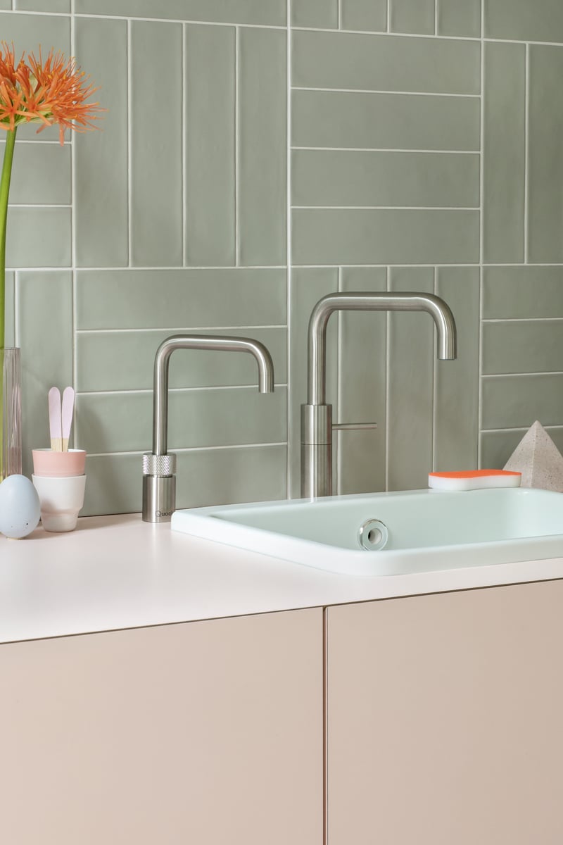 Quooker Nordic Square in stainless steel boiling water tap — twin taps, steel in a real customer kitchen. Genuine Quooker product supplied by Watertap.eu.