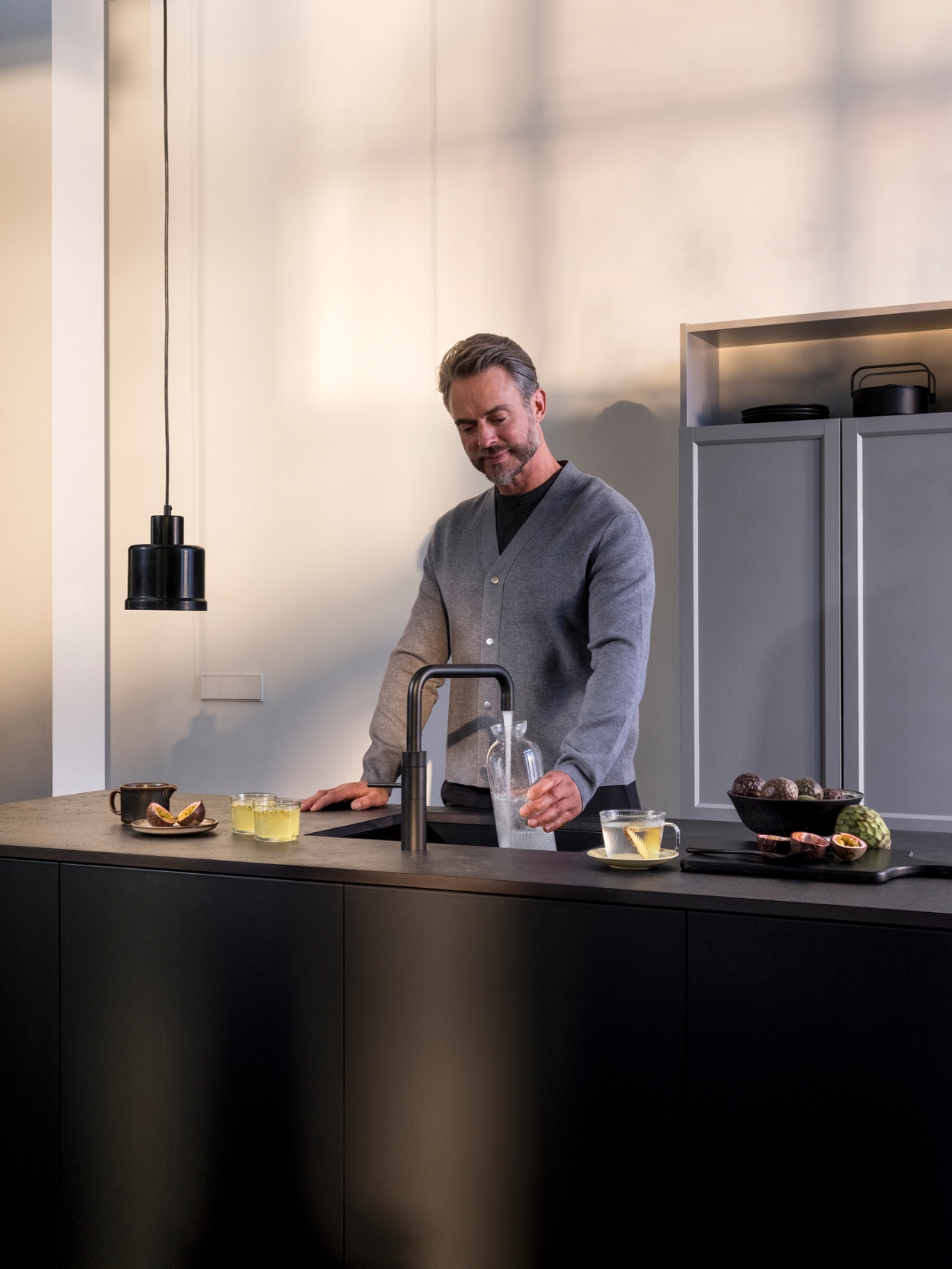 Quooker Fusion Square in black with chilled sparkling water setup in a moody architectural kitchen
