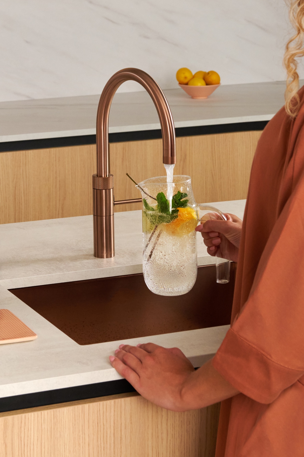 Quooker Fusion Round in rose copper boiling water tap — making lemonade in a real customer kitchen. Genuine Quooker product supplied by Watertap.eu.