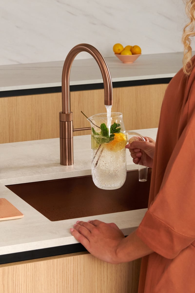 Quooker Fusion Round in rose copper boiling water tap — making lemonade in a real customer kitchen. Genuine Quooker product supplied by Watertap.eu.
