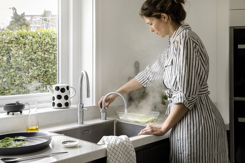 Quooker Nordic Round in stainless steel boiling water tap — twin taps, steel in a real customer kitchen. Genuine Quooker product supplied by Watertap.eu.