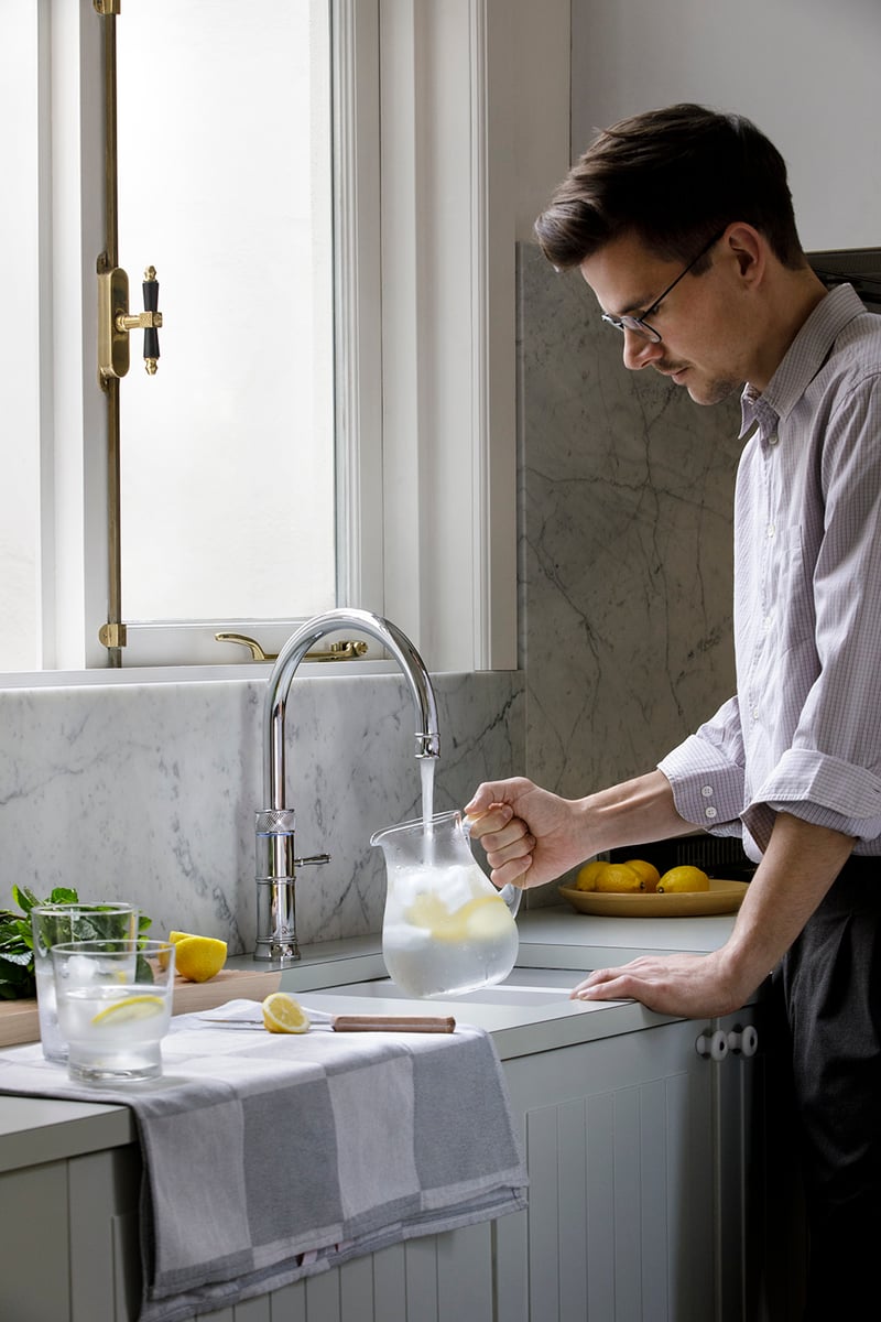 Quooker Classic Fusion Round in chrome boiling water tap — against Carrara marble in a real customer kitchen. Genuine Quooker product supplied by Watertap.eu.