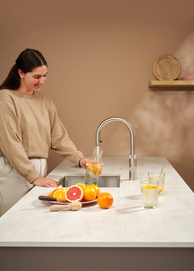 Quooker Flex Round in stainless steel boiling water tap — with grapefruit in a real customer kitchen. Genuine Quooker product supplied by Watertap.eu.