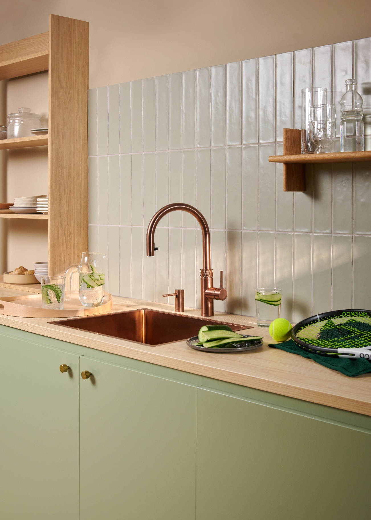 Flex Round rose copper Quooker with cucumber-infused sparkling water carafe in a sunlit kitchen