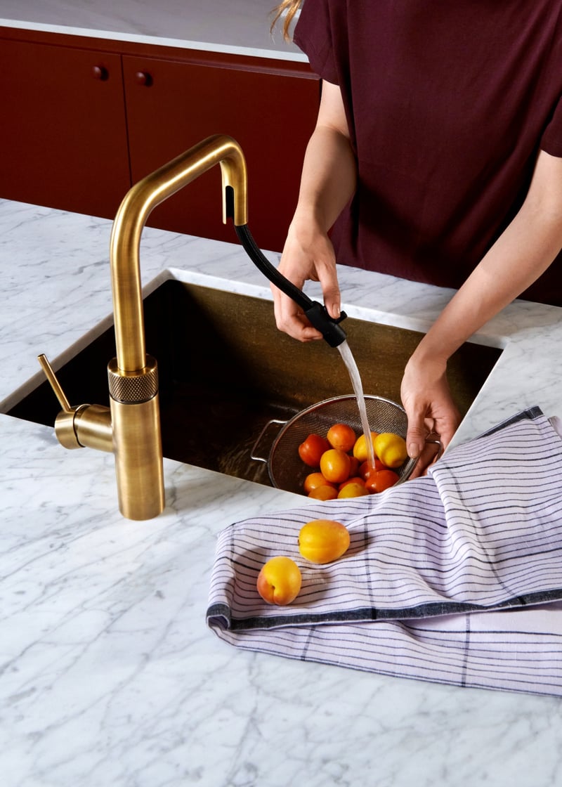 Quooker Flex Square in brass boiling water tap — with apricots in a real customer kitchen. Genuine Quooker product supplied by Watertap.eu.